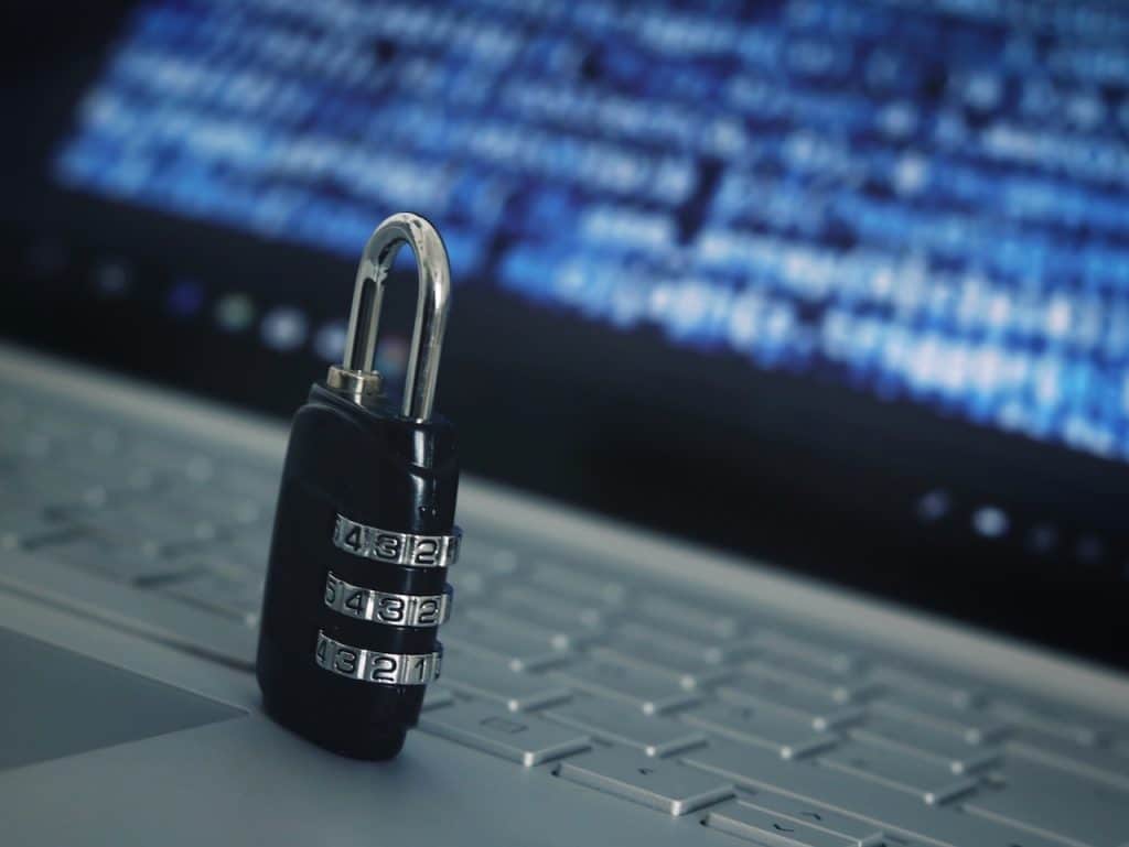 lock on laptop keyboard - ransomware risks and cyber threats