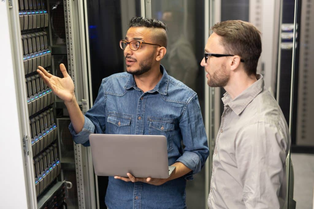 Salt Lake City managed IT services - IT technician talking with client in server room