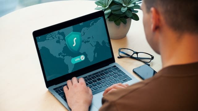 man using laptop with VPN in Utah home