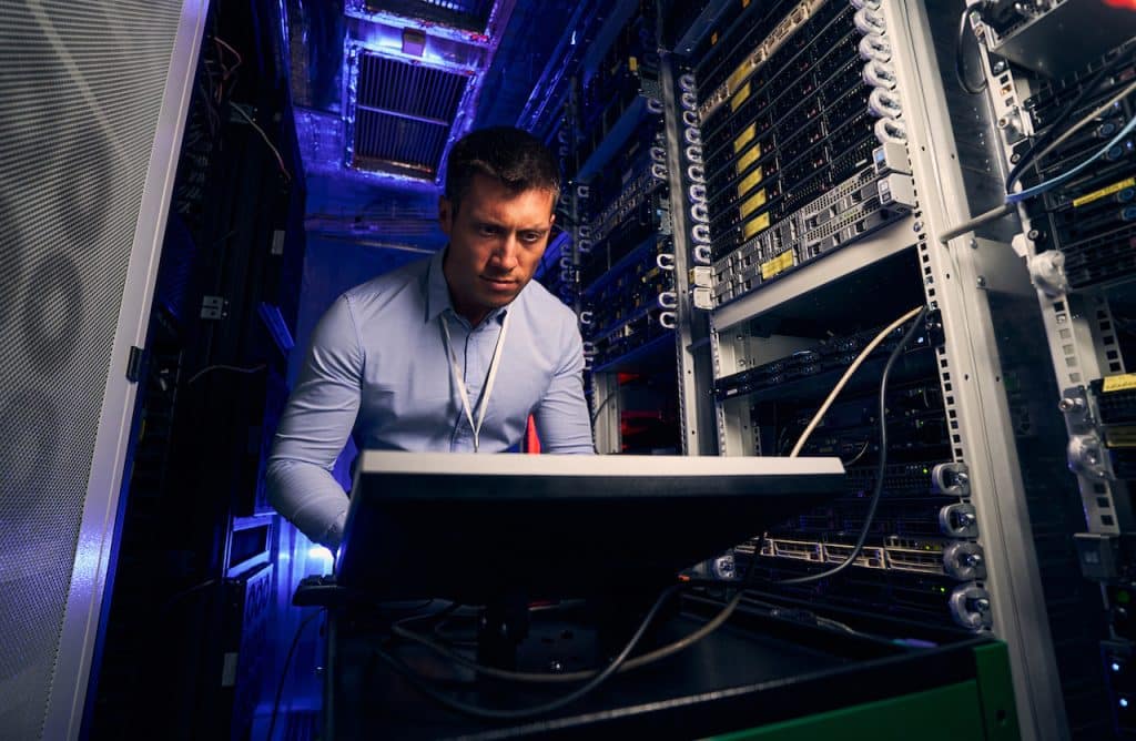 IT professional working in server room for an IT service company