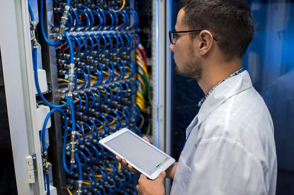 IT professional working in server room, providing IT support services
