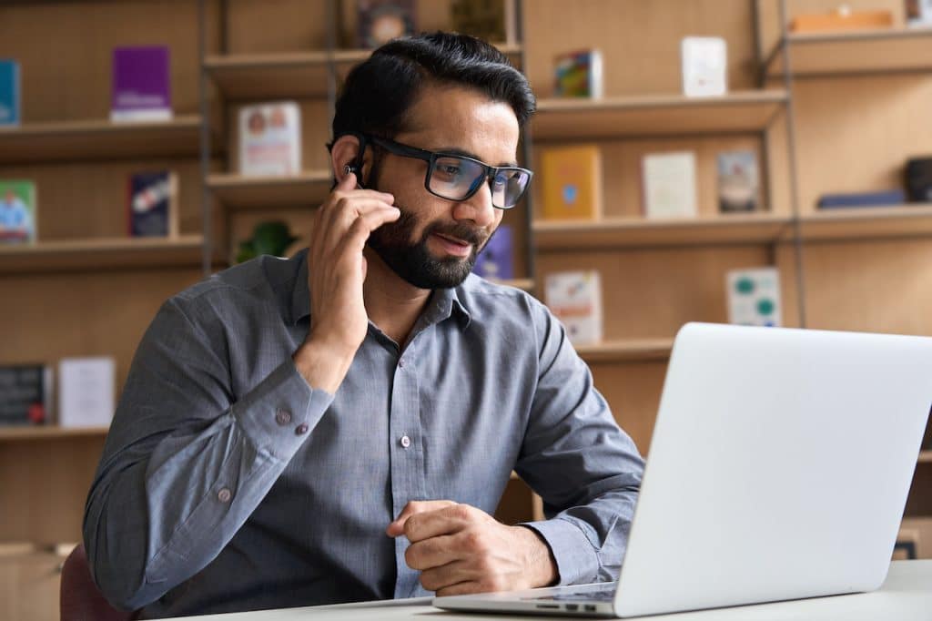remote it support services technician at his desk on a computer assisting a remote worker