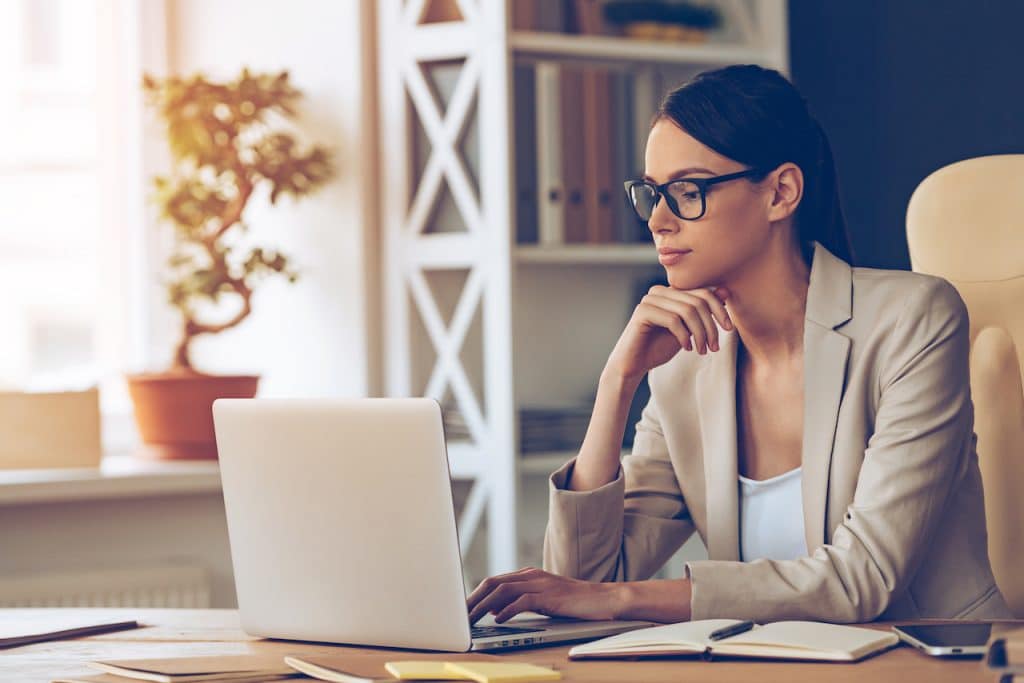 woman at home on computer utilizing benefits of it security support services while working