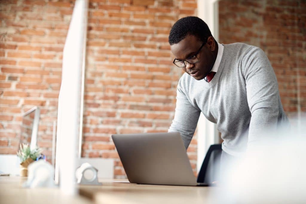man working in office supported by it company