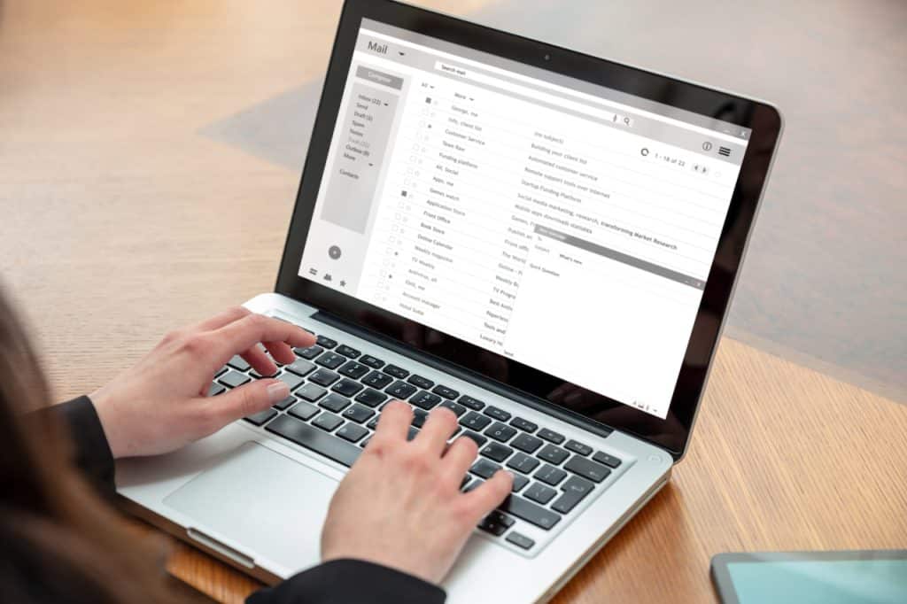 woman typing on computer avoiding email security threats
