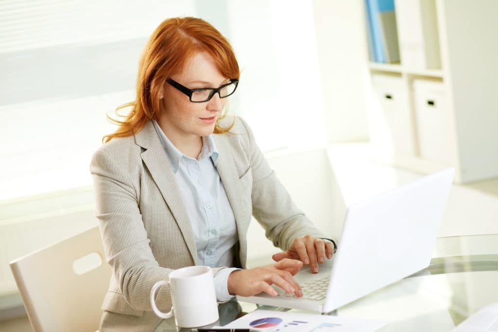 woman utilizing it support for business while at work on her computer