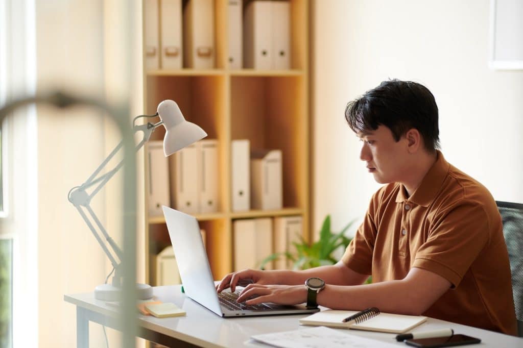 man working from home using tech support services to stay connected
