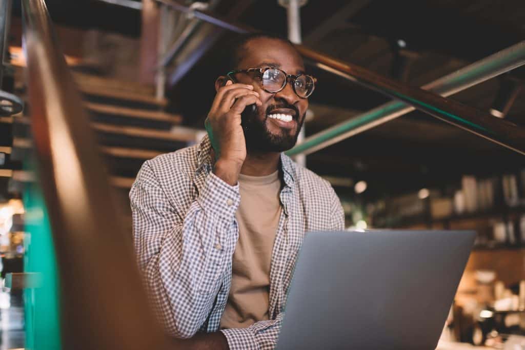 IT professional on the phone at computer providing managed it services for small businesses