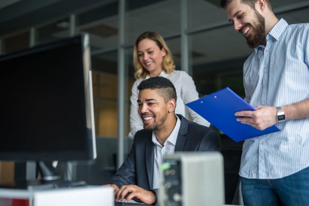 IT professionals evaluating network security on computer at office