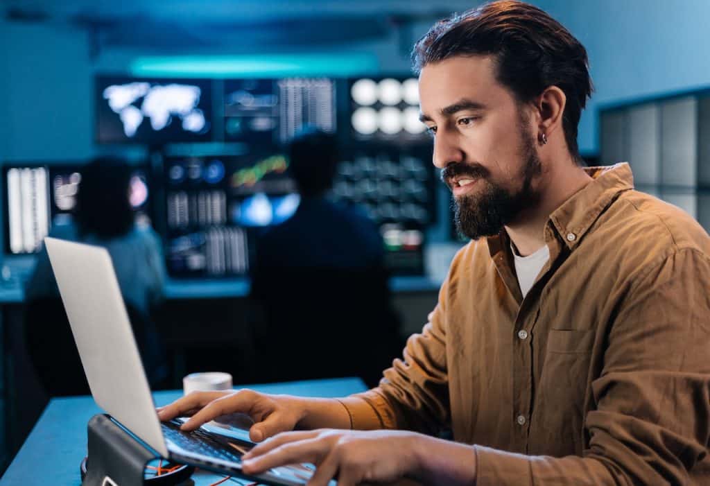 it professional working on computer in server room