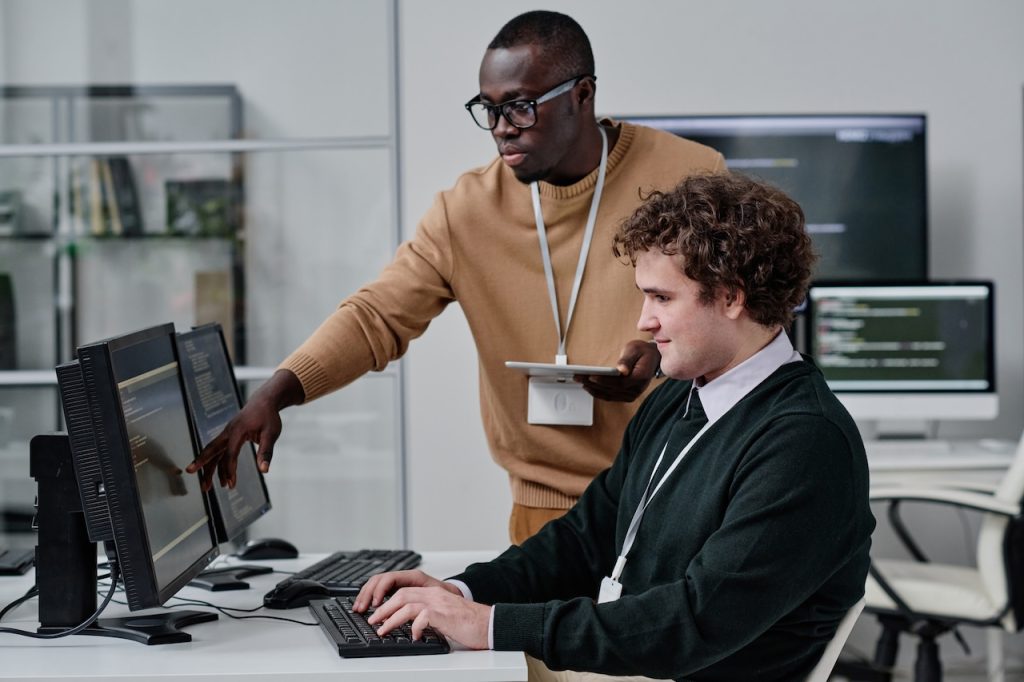 coworkers in office consulting and working on computer