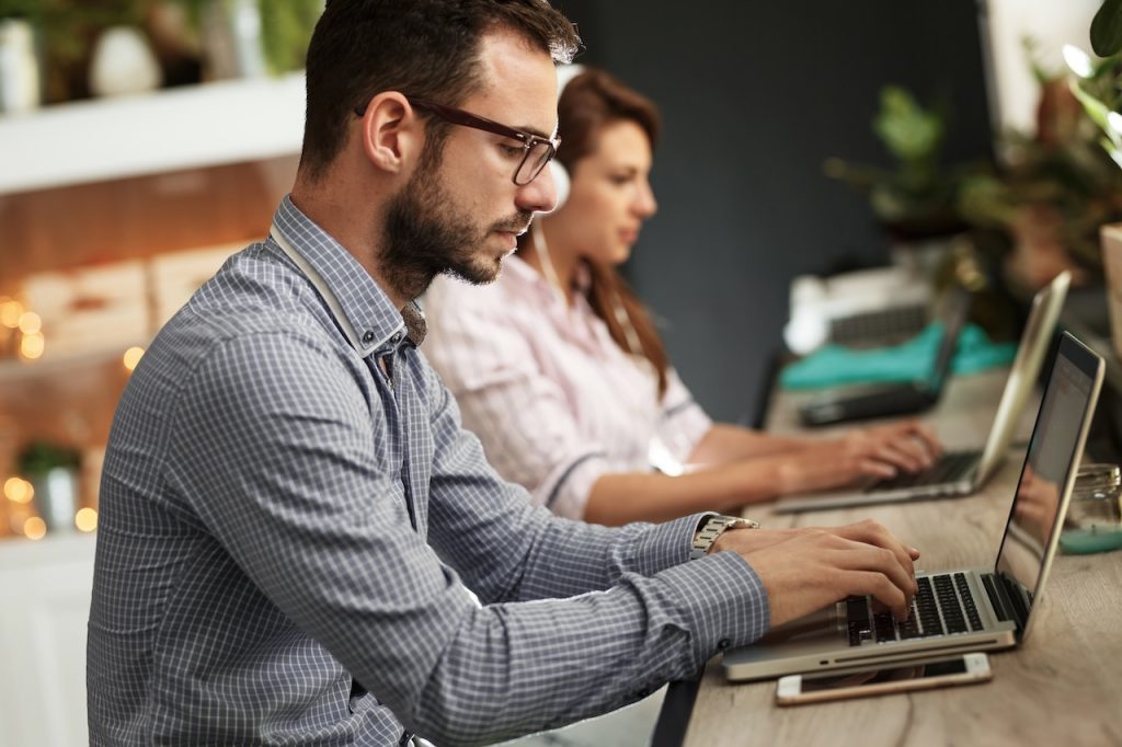 employees working on computers supported by outsourced it department